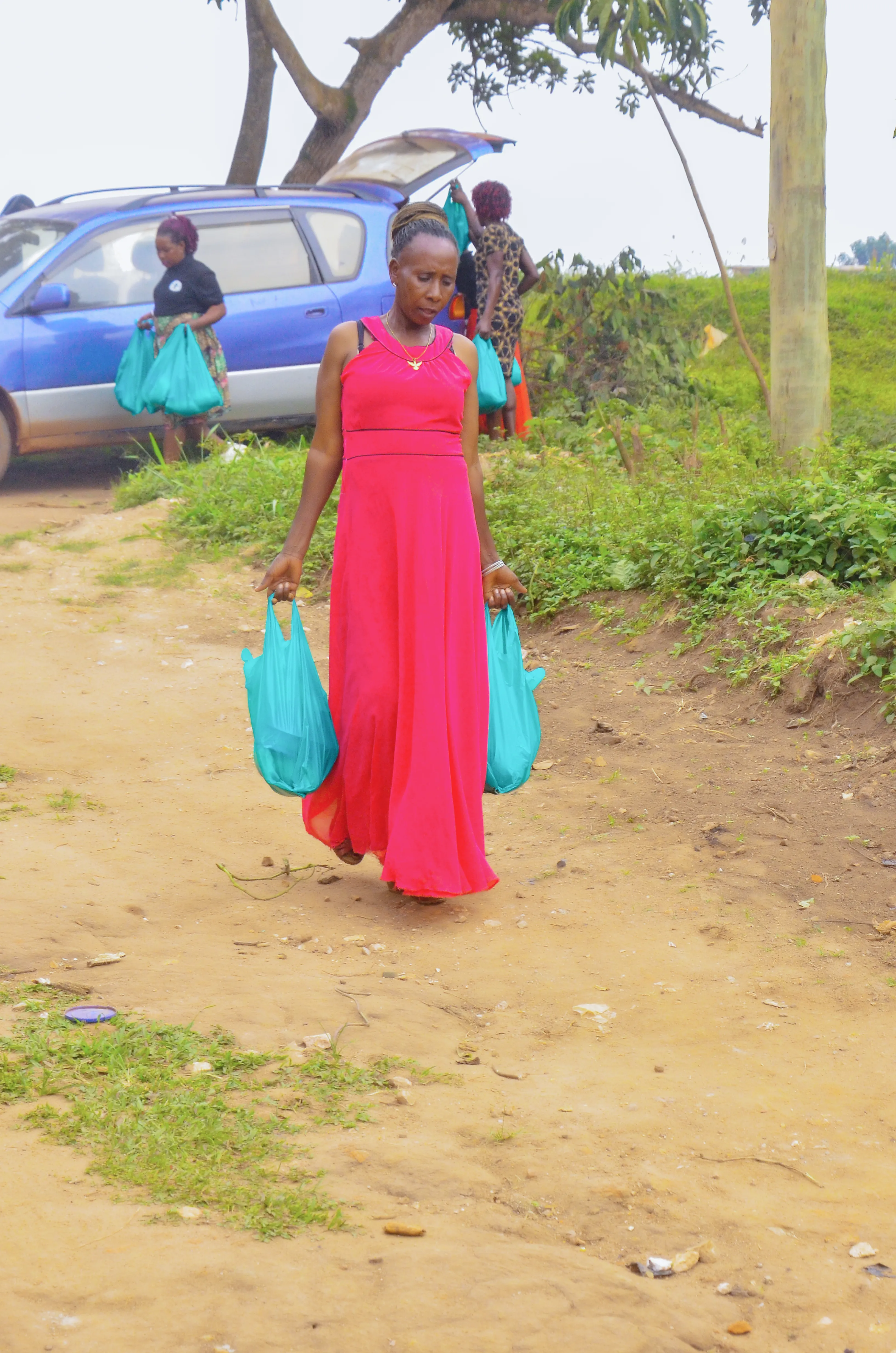 Volunteer delivering supplies through a Ugandan rural community